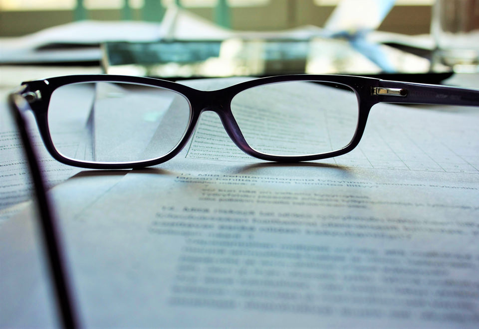 Glasses and papers on desk